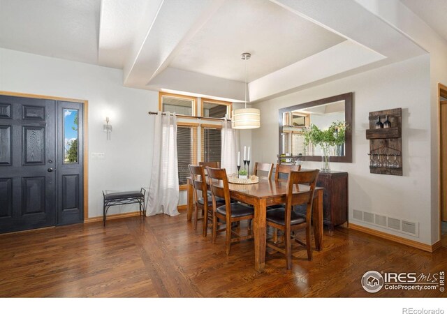 dining space with baseboards and wood finished floors