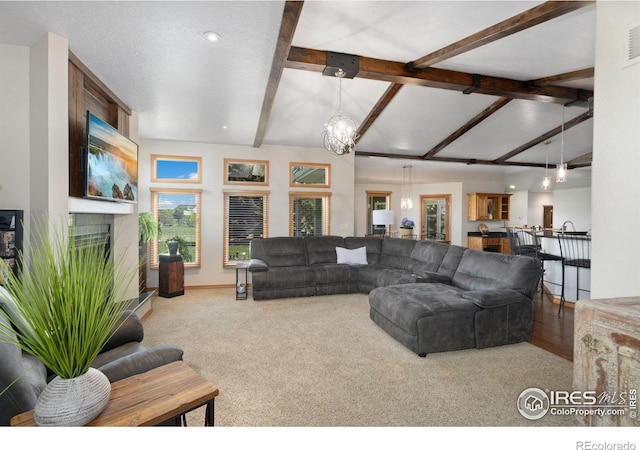 living area featuring a chandelier and carpet floors