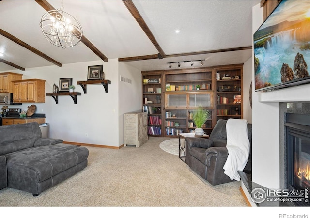 living room featuring a glass covered fireplace, carpet floors, a chandelier, beam ceiling, and baseboards