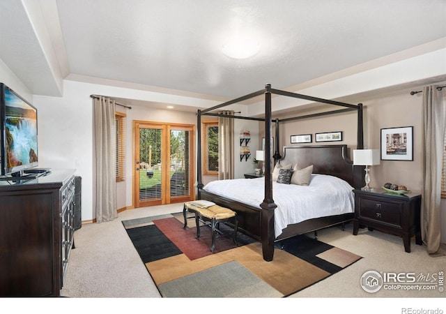 bedroom featuring light colored carpet and access to exterior