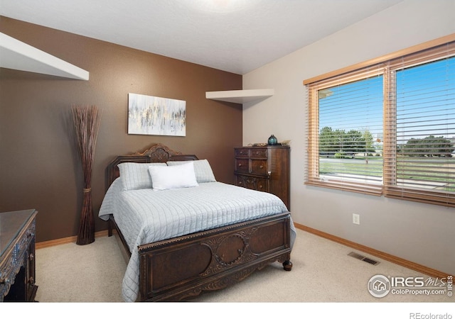 bedroom with carpet flooring and baseboards