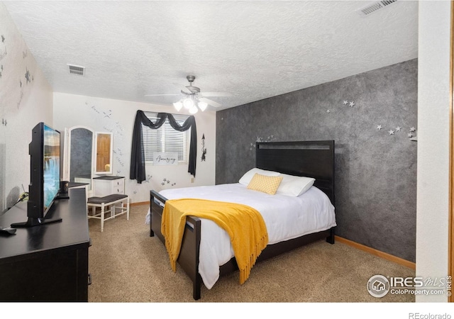 carpeted bedroom featuring a textured ceiling, ceiling fan, and baseboards