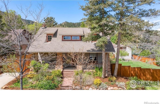 721 9th St, Boulder, CO 80302 - view of front of home featuring roof with shingles, fence, covered porch, a chimney, and a mountain view