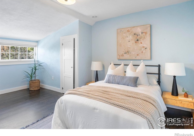 721 9th St, Boulder, CO 80302 - bedroom featuring wood finished floors, baseboards, and lofted ceiling