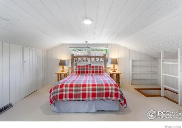 721 9th St, Boulder, CO 80302 - carpeted bedroom with lofted ceiling and wood walls