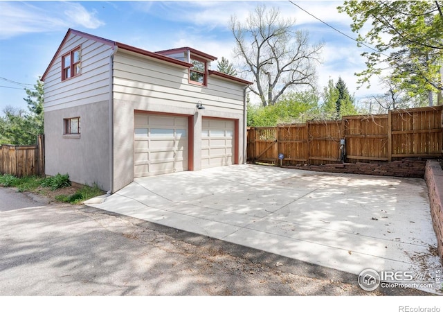721 9th St, Boulder, CO 80302 - garage featuring fence and concrete driveway