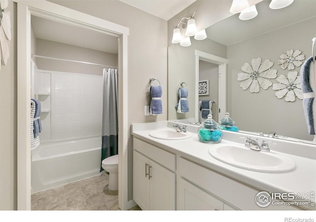bathroom with toilet, double vanity, and shower / bath combo