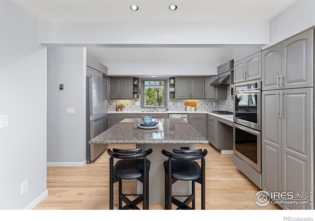 3075 Galena Way, Boulder, CO 80305 - kitchen with gray cabinetry, appliances with stainless steel finishes, a sink, a breakfast bar, and open shelves
