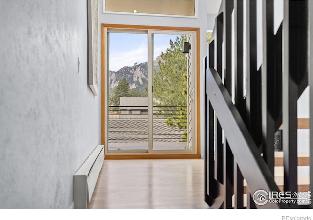 3075 Galena Way, Boulder, CO 80305 - doorway featuring a baseboard heating unit, wood finished floors, and a mountain view