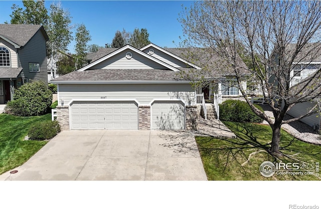 4447 Twin Peaks Dr, Loveland, CO 80537 - view of front of home featuring brick siding, a garage, concrete driveway, a shingled roof, and a front lawn