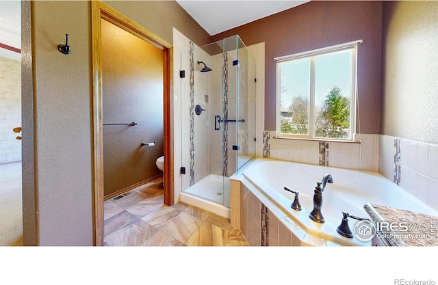 4447 Twin Peaks Dr, Loveland, CO 80537 - bathroom featuring a stall shower, a bath, toilet, and a textured wall