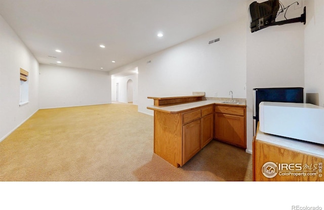 4447 Twin Peaks Dr, Loveland, CO 80537 - bar featuring arched walkways, light colored carpet, a sink, and recessed lighting