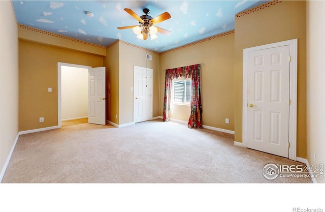 4447 Twin Peaks Dr, Loveland, CO 80537 - unfurnished bedroom featuring carpet floors, baseboards, a ceiling fan, and crown molding