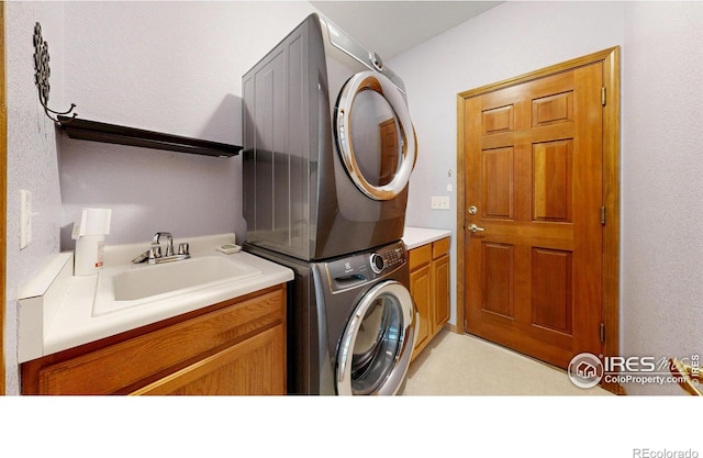 4447 Twin Peaks Dr, Loveland, CO 80537 - clothes washing area with stacked washer / dryer and cabinet space