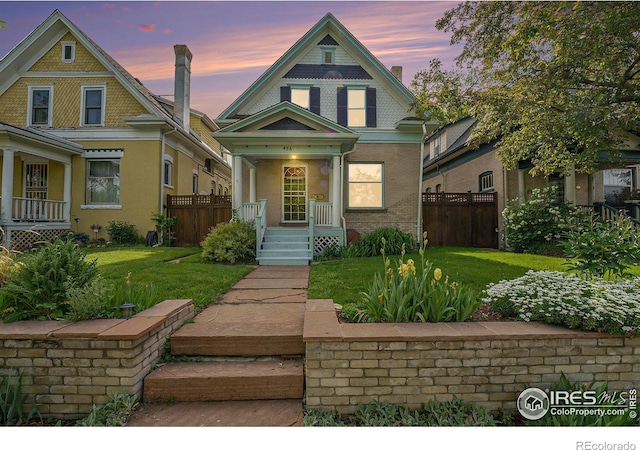 486 N Corona St, Denver, CO 80218 - victorian-style house with a porch and brick siding