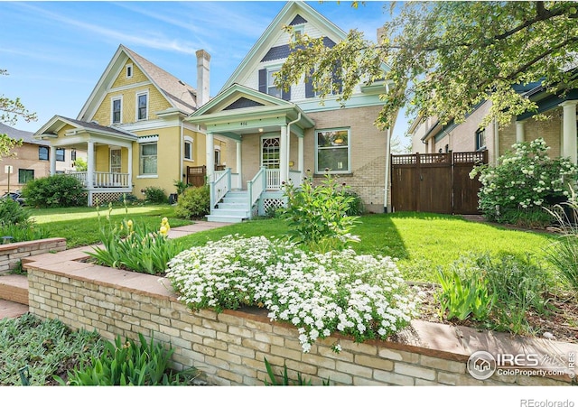 486 N Corona St, Denver, CO 80218 - victorian house featuring covered porch and brick siding