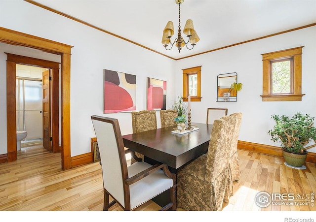 486 N Corona St, Denver, CO 80218 - dining room with a chandelier, light wood finished floors, baseboards, and crown molding