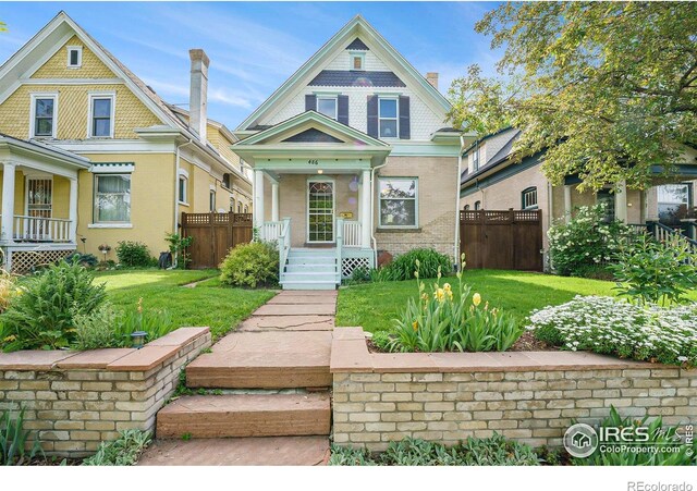 486 N Corona St, Denver, CO 80218 - victorian-style house featuring brick siding and covered porch