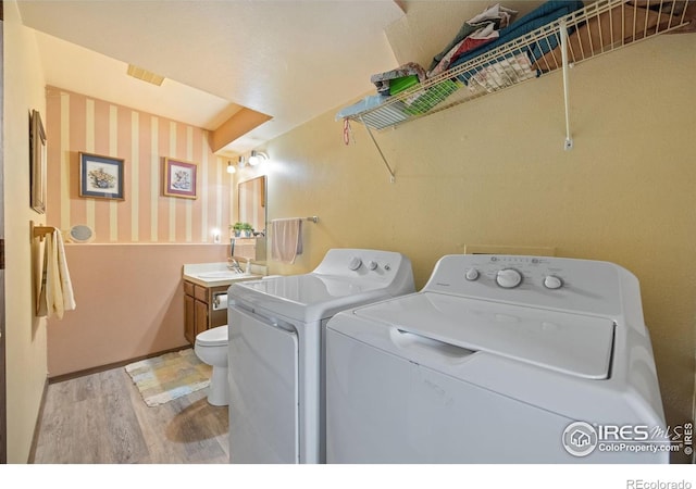 127 Lori Dr, Loveland, CO 80537 - washroom with light wood-style flooring and separate washer and dryer