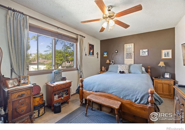 127 Lori Dr, Loveland, CO 80537 - bedroom with carpet, a textured ceiling, and a ceiling fan