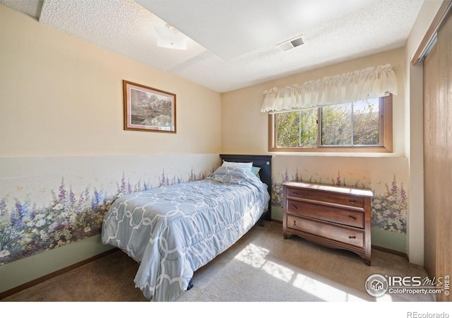 127 Lori Dr, Loveland, CO 80537 - carpeted bedroom featuring a textured ceiling, baseboards, and a closet