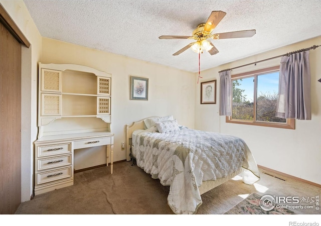 127 Lori Dr, Loveland, CO 80537 - carpeted bedroom with a textured ceiling, a ceiling fan, baseboards, and a closet