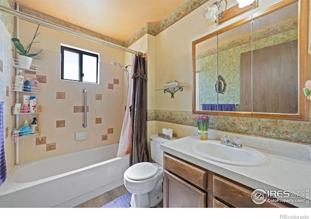 127 Lori Dr, Loveland, CO 80537 - full bathroom featuring toilet, vanity, shower / bath combination with curtain, and wood finished floors