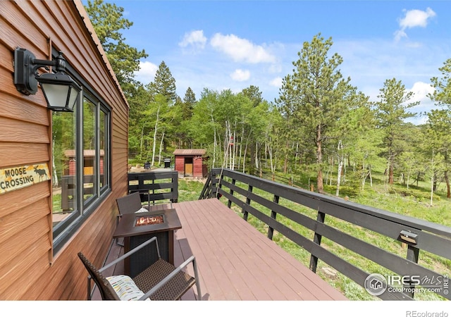 133 Rockledge Cir, Allenspark, CO 80540 - wooden deck with a fire pit and a storage shed