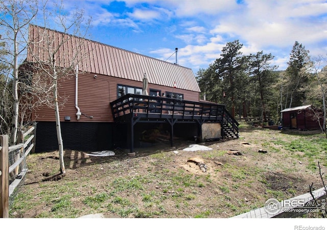 133 Rockledge Cir, Allenspark, CO 80540 - rear view of house with a wooden deck and a metal roof