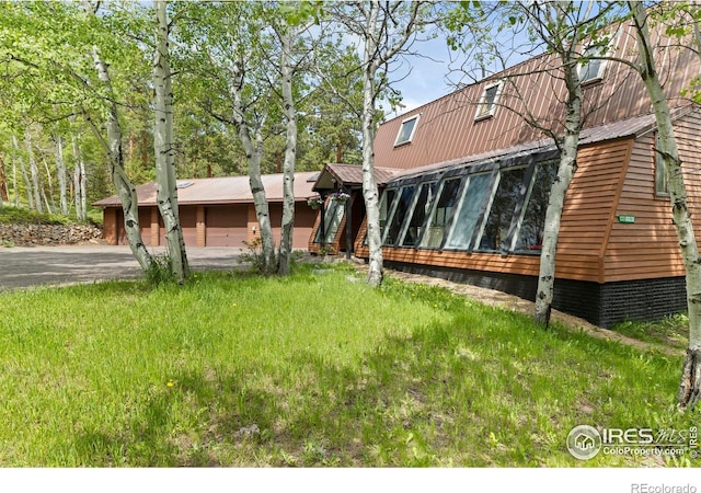 133 Rockledge Cir, Allenspark, CO 80540 - view of front of house with a sunroom and a metal roof