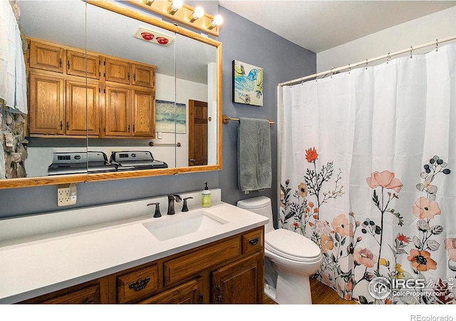 133 Rockledge Cir, Allenspark, CO 80540 - full bath featuring washer / dryer, vanity, wood finished floors, and a shower with curtain
