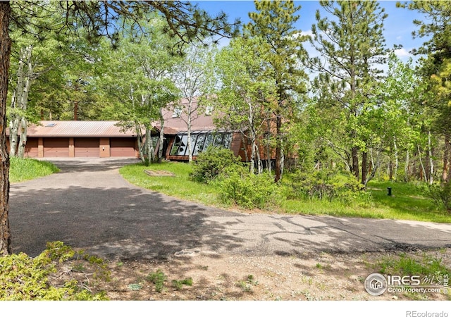133 Rockledge Cir, Allenspark, CO 80540 - view of front of house featuring asphalt driveway, a metal roof, and an attached garage