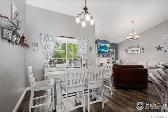 2015 Trail Ridge Dr, Severance, CO 80615 - dining area with a chandelier, wood finished floors, lofted ceiling, and baseboards