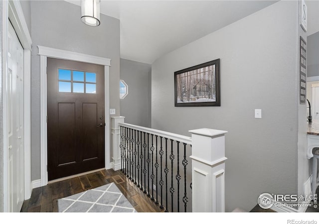 2015 Trail Ridge Dr, Severance, CO 80615 - entryway with dark wood-style floors and baseboards