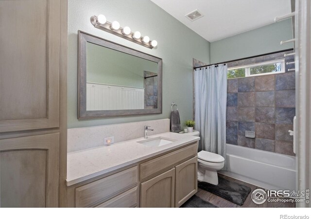 2015 Trail Ridge Dr, Severance, CO 80615 - bathroom featuring toilet, vanity, and shower / tub combo
