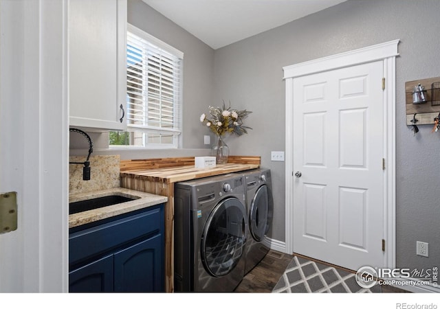2015 Trail Ridge Dr, Severance, CO 80615 - clothes washing area with separate washer and dryer, cabinet space, and dark wood-style floors