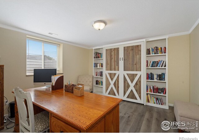2015 Trail Ridge Dr, Severance, CO 80615 - home office featuring wood finished floors and crown molding