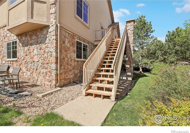 view of exterior entry with stone siding and stucco siding