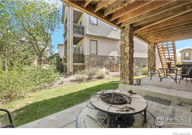 view of patio / terrace featuring a fire pit