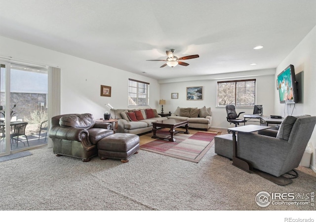 living room featuring a ceiling fan and plenty of natural light