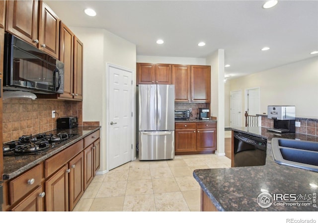 kitchen featuring black appliances, backsplash, light tile patterned flooring, recessed lighting, and a sink