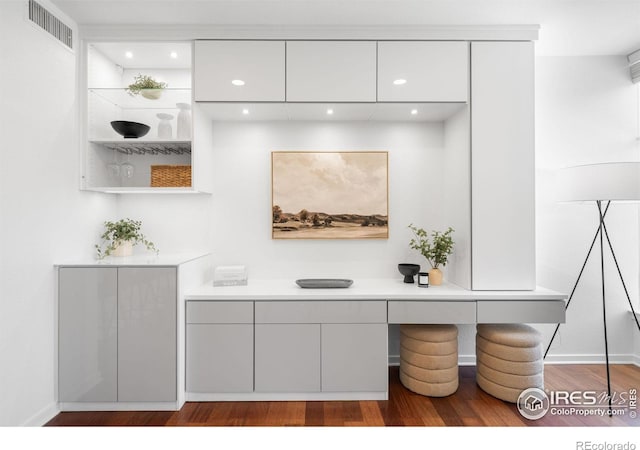 bar area featuring wood finished floors, recessed lighting, and baseboards