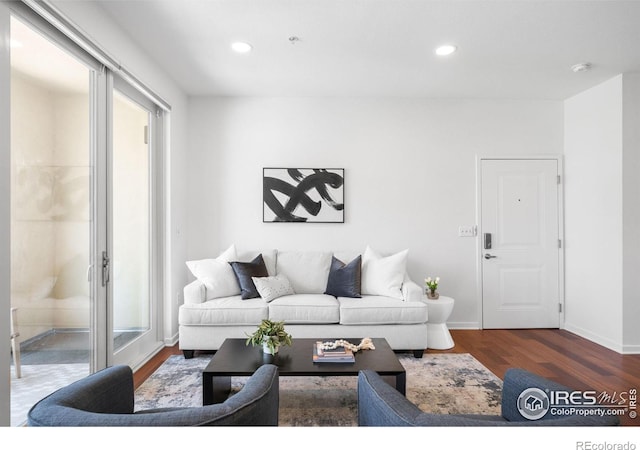 living room featuring wood finished floors, recessed lighting, and baseboards
