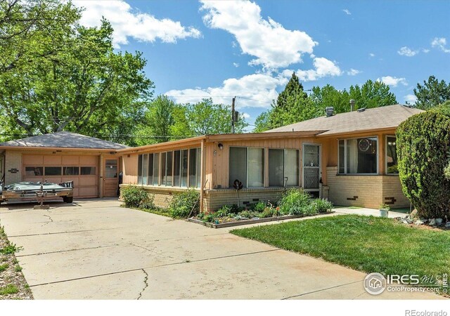 1235 Lincoln St, Longmont, CO 80501 - ranch-style home featuring brick siding, concrete driveway, a garage, and a front yard