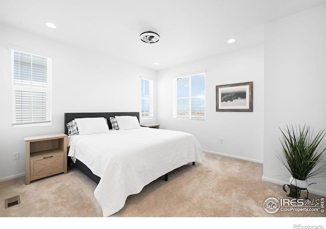 bedroom featuring light carpet, baseboards, and recessed lighting