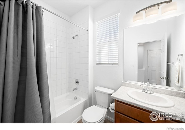 bathroom with shower / bath combination with curtain, toilet, and vanity