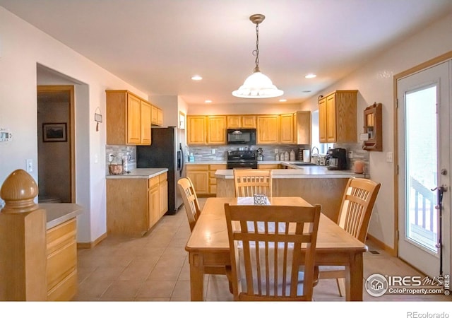 1734 68th Ave, Greeley, CO 80634 - kitchen with black appliances, tasteful backsplash, light countertops, pendant lighting, and light tile patterned floors