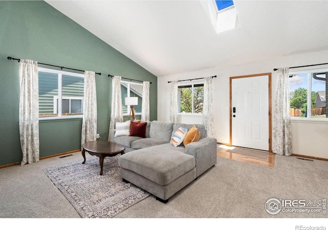 833 Kaitlyn Cir, Loveland, CO 80537 - living area featuring carpet floors, baseboards, a skylight, and high vaulted ceiling
