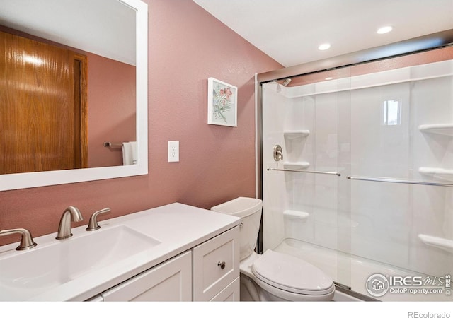 833 Kaitlyn Cir, Loveland, CO 80537 - bathroom with a stall shower, a textured wall, toilet, and vanity