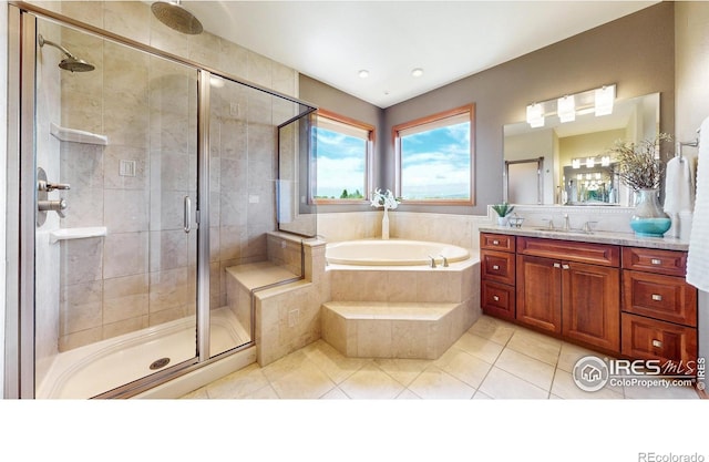 bathroom with a bath, a shower stall, tile patterned flooring, and vanity